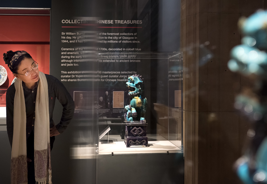 Lady looking at an object in a glass cabinet