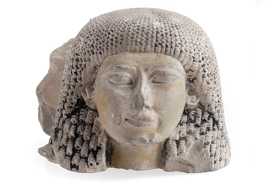 Image shows a stone head of a lady