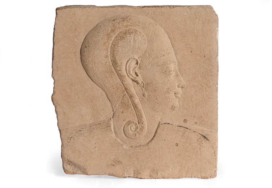 Image shows a photograph of a raised relief sculpture of a prince wearing the sidelock of youth