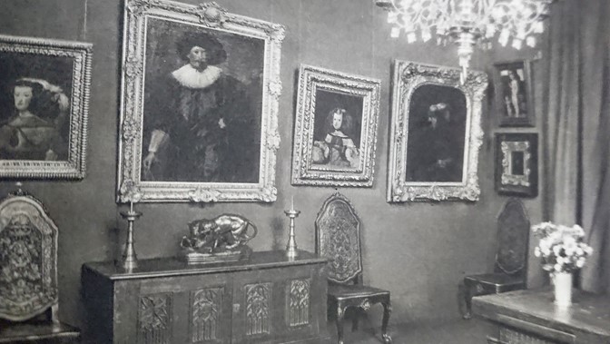 internal shot of a room with picture frames on wall 