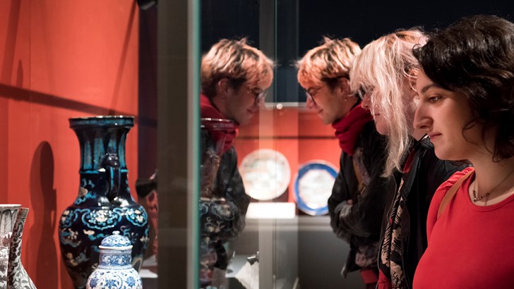 Ladies looking at objects in a glass cabinet