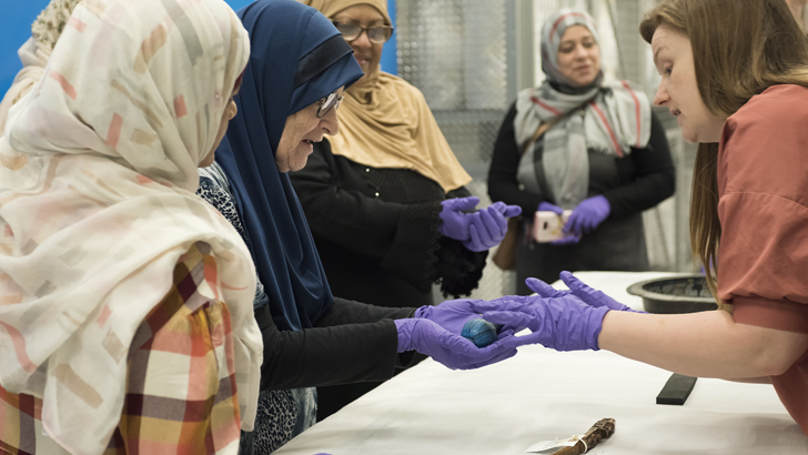 Group looking at objects from a handling box