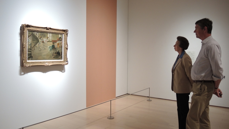 The Princess Royal and her husband looking at one of the Burrell Collection paintings on the gallery wall