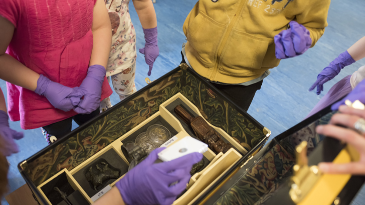 Children looking at handling boxes