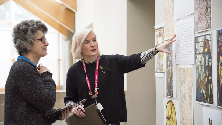 Two ladies looking at artwork